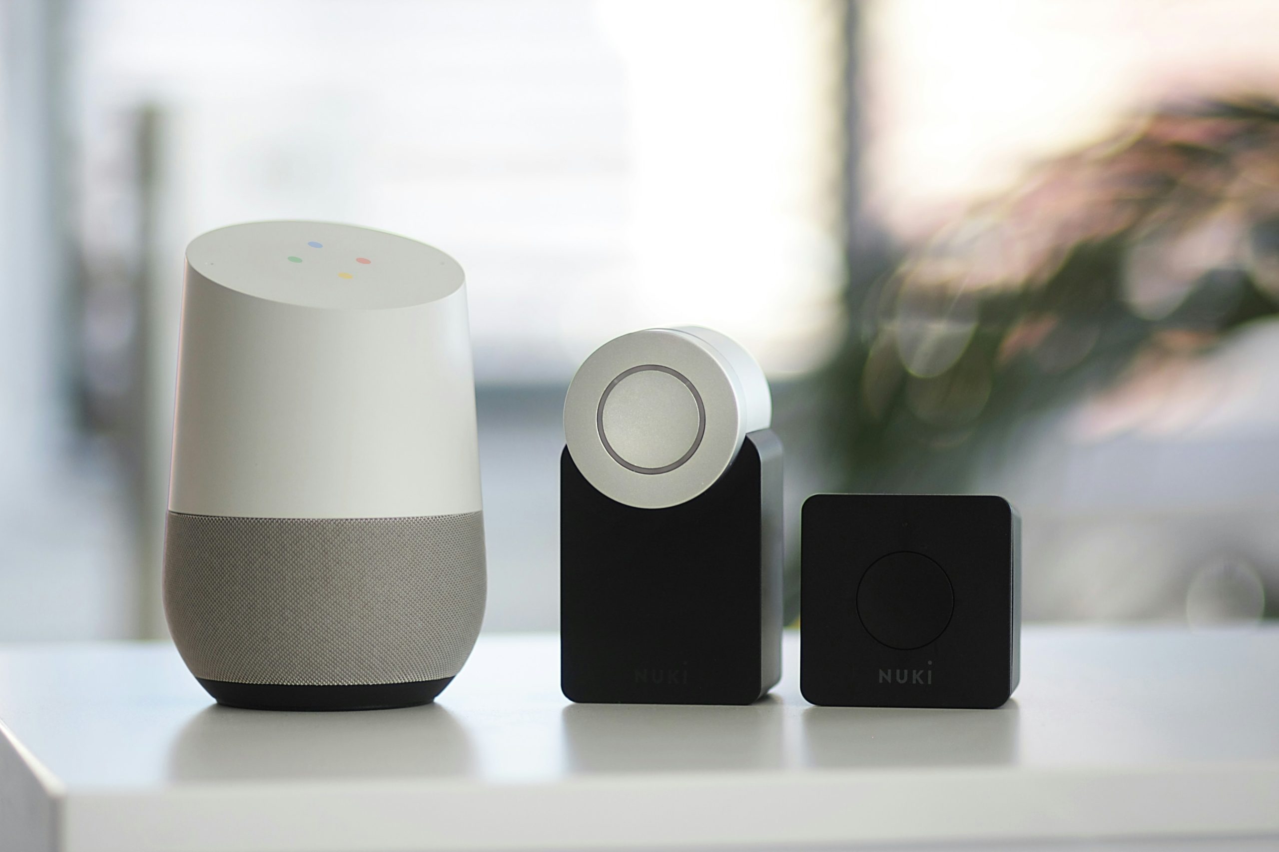Smart home speaker, door bell and camera are displayed on a modular homes counter