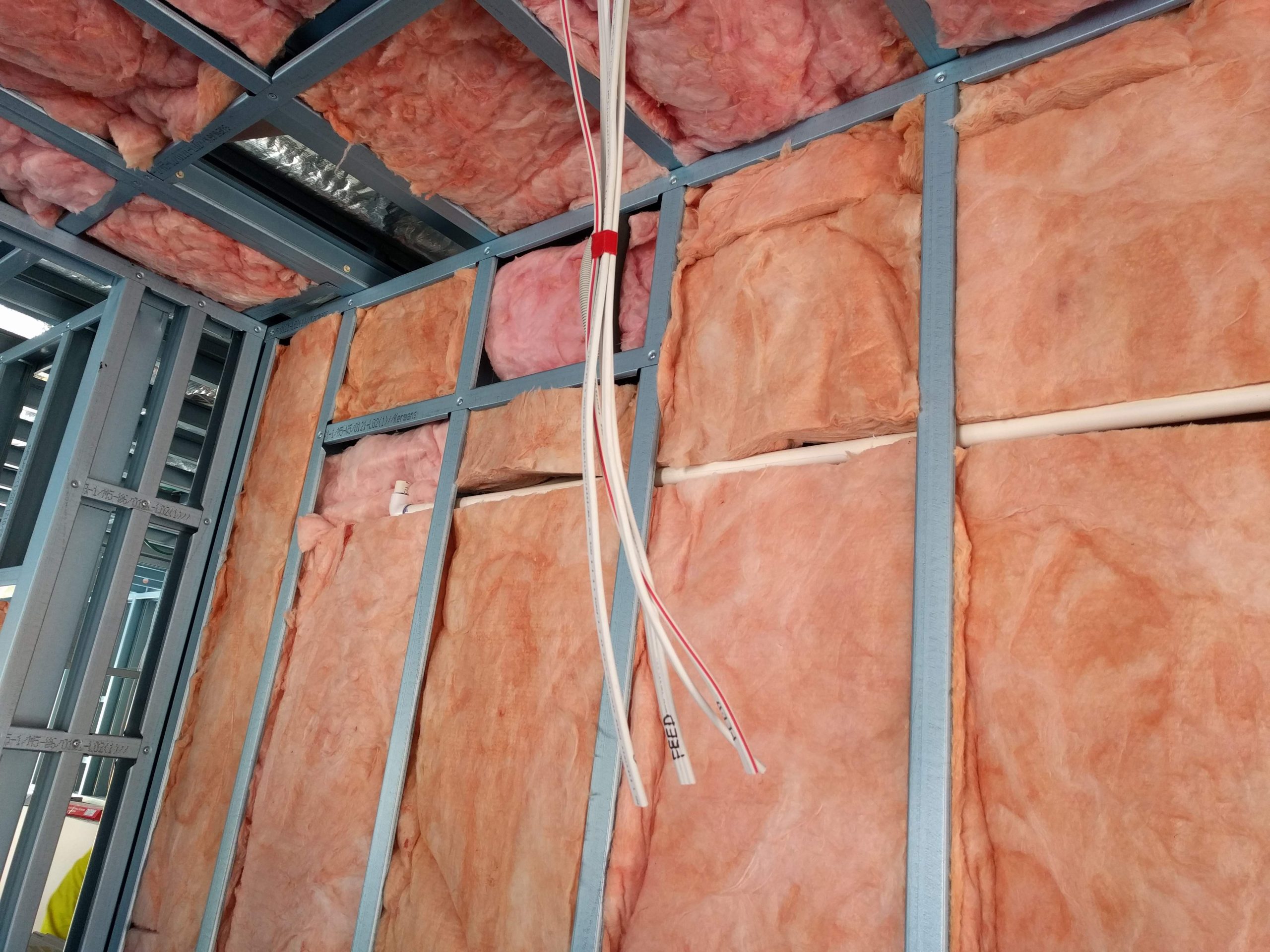 Open frame wall shows the extent of insulation used in modular construction
