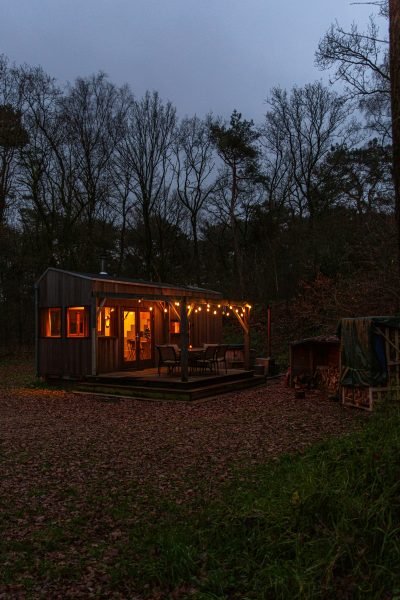 Timber deck connects to a prefab cabin for outdoor living
