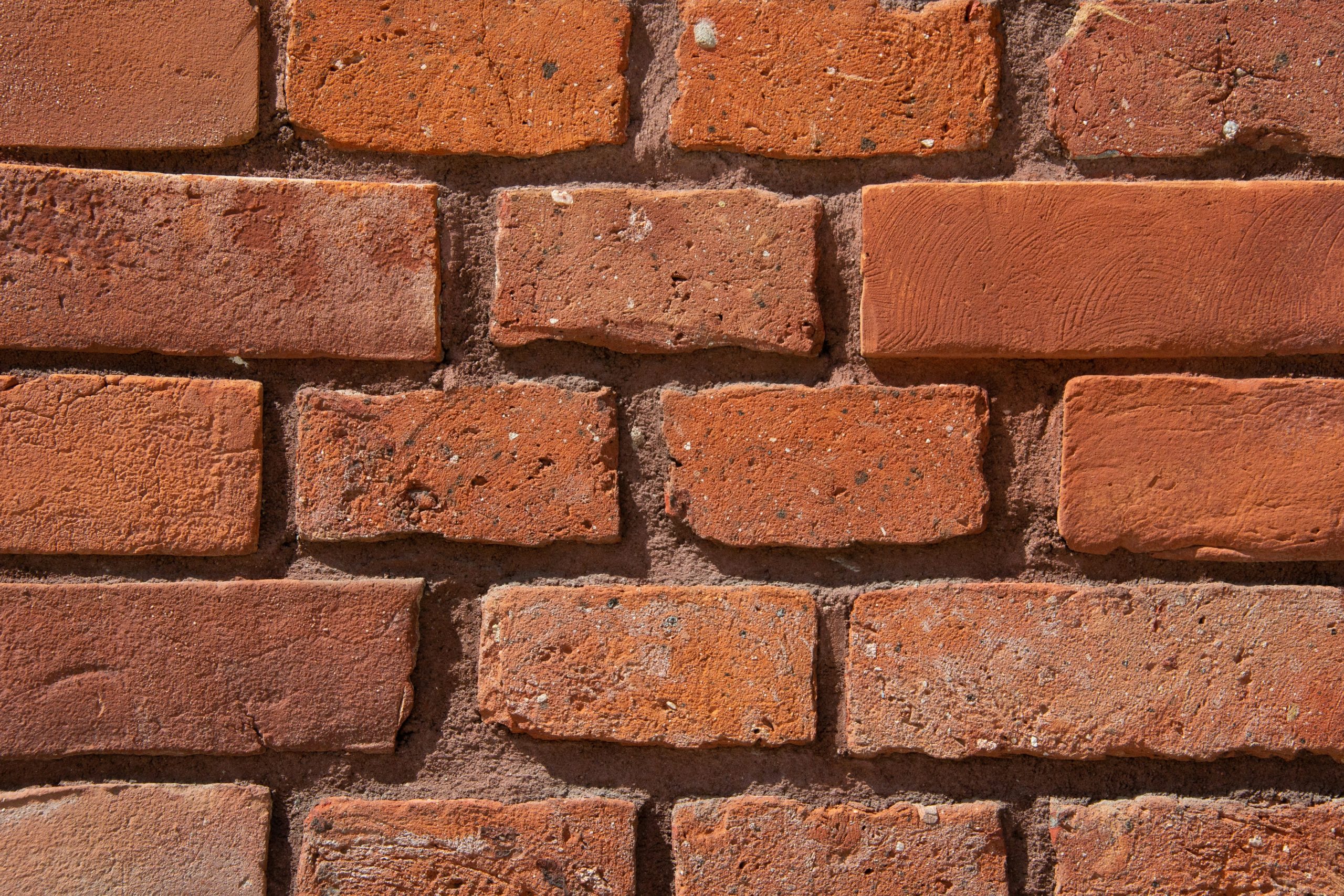 Detailed view of weathered red bricks laid in a modular pattern